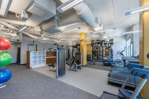 a gym with treadmills and exercise equipment in a building at Wonderful 2BR Apartment at Crystal City in Arlington
