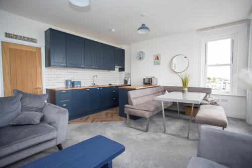 a living room with a couch and a table at Lovely 3-Bedroom Apartment with Stunning Sea Views in Worthing