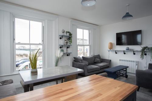 a living room with a couch and a table at Lovely 3-Bedroom Apartment with Stunning Sea Views in Worthing