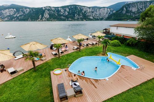 an overhead view of a swimming pool next to a lake at Pensiunea Decebal Resort - Cazanele Dunarii in Dubova