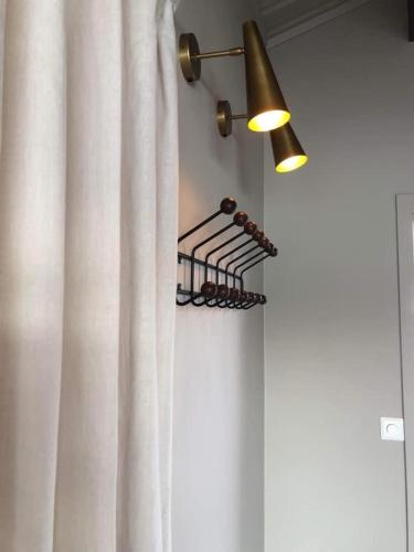 a white shower curtain with a light and a lamp at Yttervik in Mo i Rana