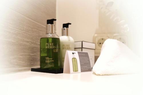 a shelf with two bottles of soap and a towel at ... mein romantisches Hotel Toalstock in Fiss
