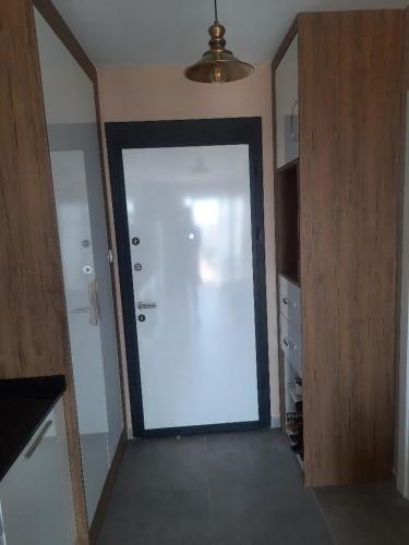 a large white door in a room at Дизайнерская студия с отдельной спальней на первой береговой линии Four Seasons Iskele in Iskele