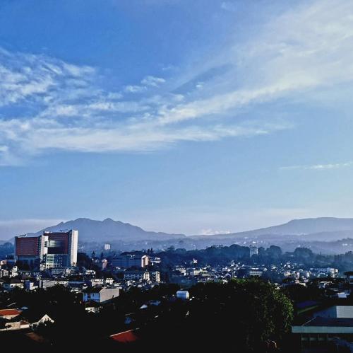 a view of a city with mountains in the background at 1010 - Bohemian Apartment in Bandung