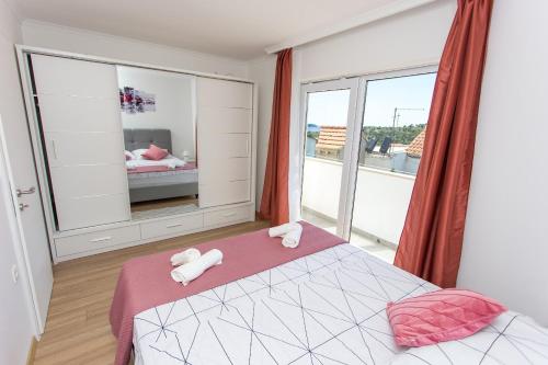 a bedroom with a bed and a large window at Holiday House Sea La Vie in Mlini