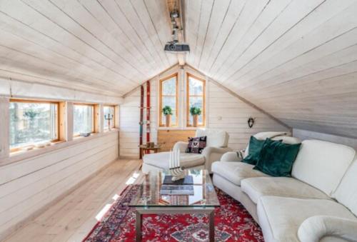 a living room with a couch and a table at Mysig fjällstuga med direktanslutning till fjället in Oviken