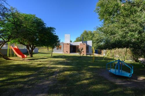a playground with a slide in a yard at Casas Acrux in Nono