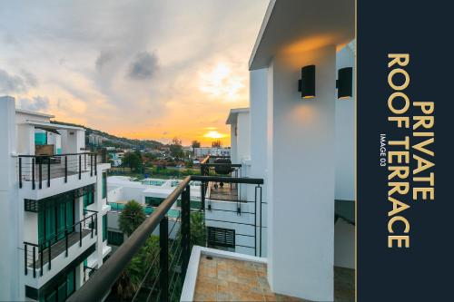 a view from the balcony of a building with a sunset at 3 BR Stylish Condo with Private Rooftop Pool in Kamala Beach
