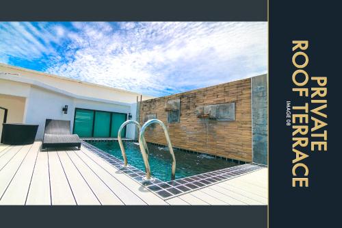 a swimming pool in a house with a wooden deck at 3 BR Stylish Condo with Private Rooftop Pool in Kamala Beach