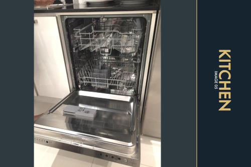 a dishwasher with its door open in a kitchen at 3 BR Stylish Condo with Private Rooftop Pool in Kamala Beach