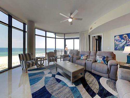 a living room with a couch and a table at Capri #301 in Perdido Key