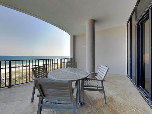 a table and chairs on a balcony with the ocean at Capri #301 in Perdido Key