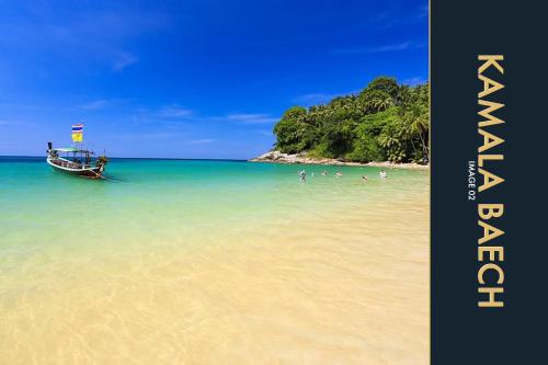 a boat on a beach with people in the water at 3 BR Stylish Condo with Private Rooftop Pool in Kamala Beach