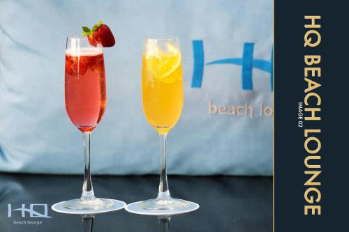 two wine glasses filled with different types of drinks at 3 BR Stylish Condo with Private Rooftop Pool in Kamala Beach