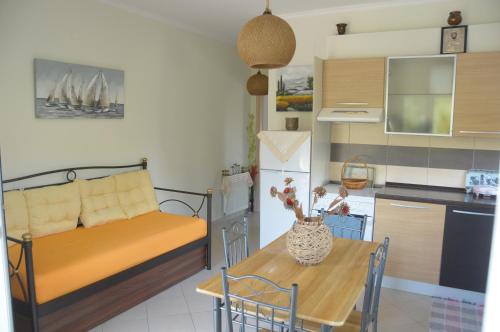 a living room with a couch and a table in a kitchen at Maria Apartments in Lefkada Town