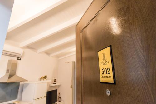 une porte dans une pièce munie d'un panneau. dans l'établissement Nikaj Premium Apart-Hotel, à Vlorë