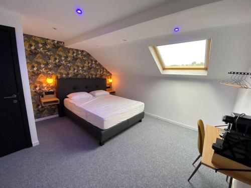 a bedroom with a large bed and a window at BED Cauchy in Namur