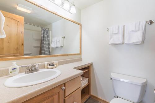 a bathroom with a sink and a toilet and a mirror at Alpenglow Unit 6 in Ouray