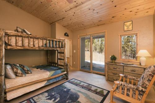 a bedroom with a bunk bed and a desk at Rincon Ridge Road in Durango