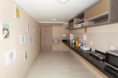 a kitchen with a long hallway with a counter at Pousada Villa Goyá in São José da Coroa Grande