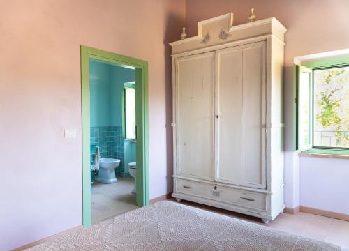 a bathroom with a white cabinet and a toilet at Il casale dei nonni in Grottazzolina