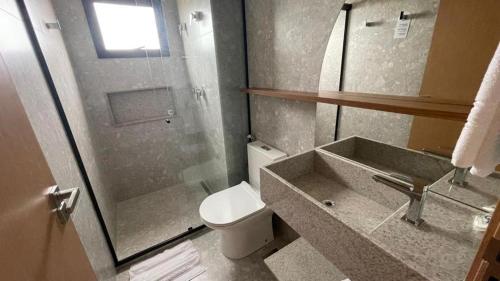 a bathroom with a toilet and a sink and a shower at SALINAS PREMIUM RESORT in Salinópolis