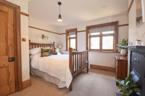 a bedroom with a bed and a window at Unique period one bedroom house in Colchester in Colchester