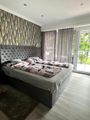 a bedroom with a large bed and a window at Barbara Vendégház in Balatonfüred