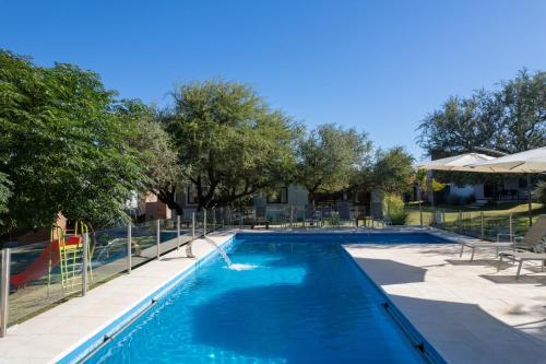 a swimming pool with a slide and a playground at Casas Acrux in Nono