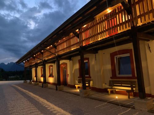 a building with benches on the side of the road at AGRITURISMO MODOLO Belluno Dolomiti in Belluno
