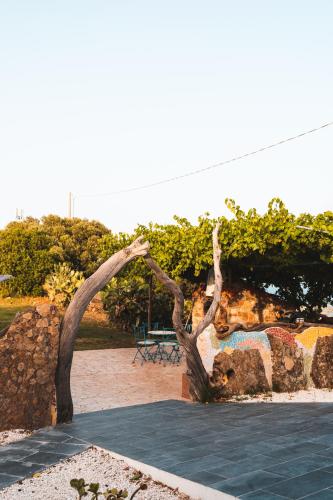 a statue of two trees in a park at Agriturismo Irghitula in Posada