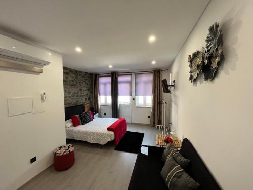 a living room with a bed and a couch at Alojamento Joaninha Douro 2 in Peso da Régua