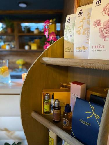 a shelf with products on it in a store at Ethno Houses Plitvice Lakes Hotel in Plitvica selo