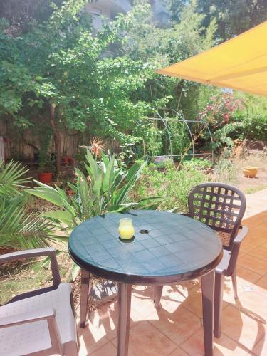 a table and chairs with a cup on top of it at Cosy Studio en résidence privée in Marseille