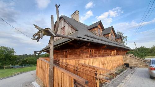 a wooden house with a star on it at Browar POD CZARNYM KOGUTEM in Cieszyn