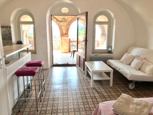 een woonkamer met een bank en een tafel bij Studio de charme avec grande terrasse vue mer in Le Castellet