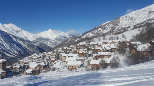 a small town covered in snow on a mountain at appartement Ancolie in Saint-Martin-de-Belleville