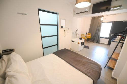 a bedroom with a bed in a room with a window at Suites in the Galilee in Qiryat Shemona