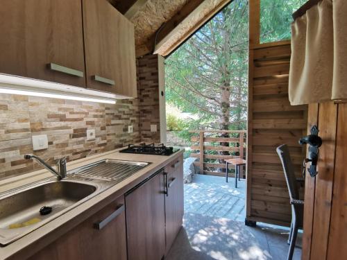 a kitchen with a sink and a counter top at Glamping Narnia in Bovec
