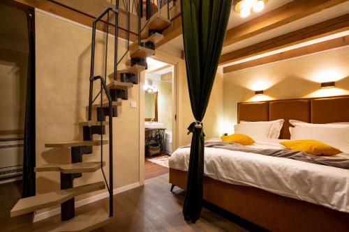 a bedroom with a bed and a spiral staircase at Luxury Villa Trtoja - with e-cars station in Svetvinčenat