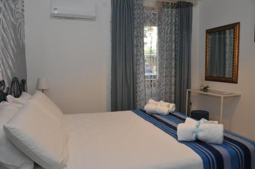 a bedroom with a white bed with towels on it at Come a casa in Cava deʼ Tirreni