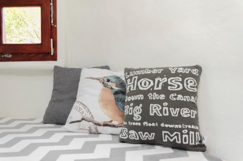 a pillow on a bed with a bird on it at Krka Magic Pumpkin in Rupe