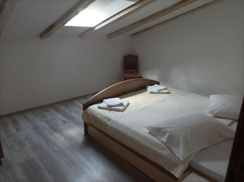 a bedroom with a bed with two towels on it at Feel Good Apartment Rab Mundanije 131 in Mundanije