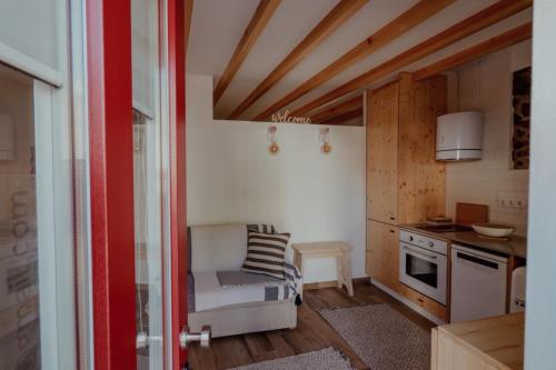 a small kitchen with a chair in a room at Refúgio do Paixão in Sesimbra