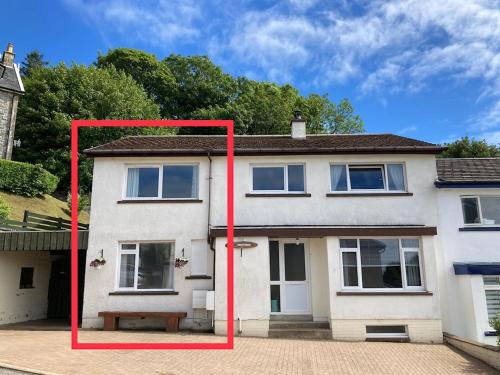 a large white house with a red frame around it at Edgemont Annexe Oban in Oban