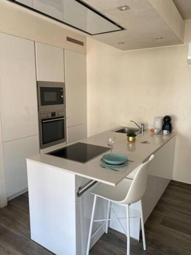 a kitchen with a counter with a sink and a stove at Lovely One Bedroom Apartment in City Center with Parking, near Public Transport in Luxembourg