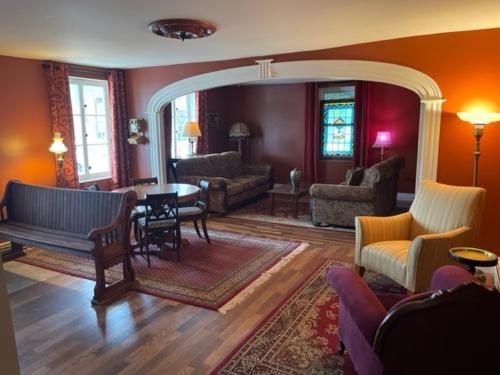 a living room with a couch and a table at Le saint Louis in Lotbinière