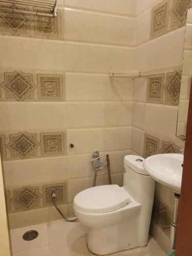 a bathroom with a toilet and a sink at Hotel Temple On Ganges in Varanasi