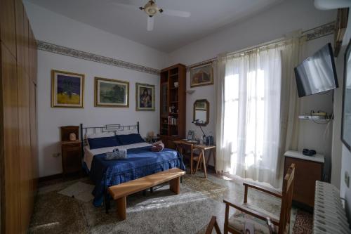 a bedroom with a blue bed and a window at Casa Franz in Tropea