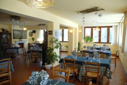 a dining room with blue tables and chairs at Hotel Valle dell' Oro in Pescasseroli